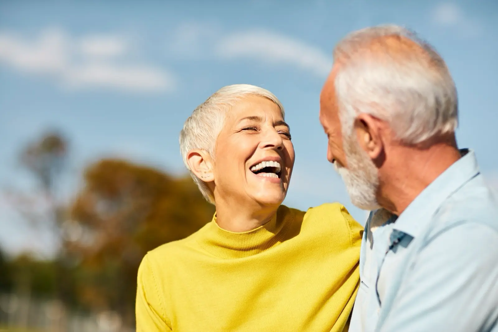 Elderly couple smiling outside